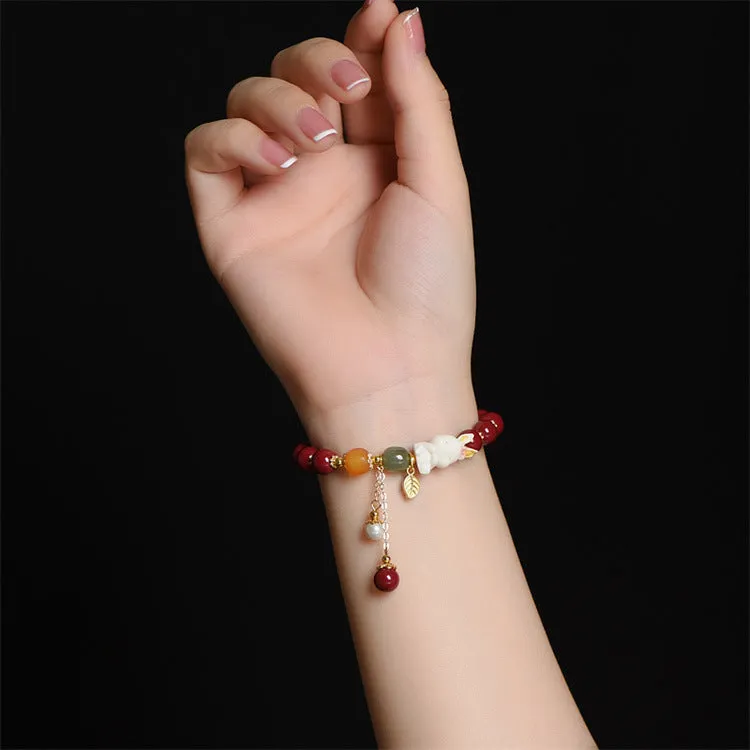 Tian Yu natural cinnabar bracelet with rabbit design in 8mm or 10mm sizes