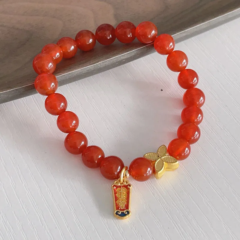 Close-up of a handmade red agate bracelet for women with a traditional Chinese dragon design.