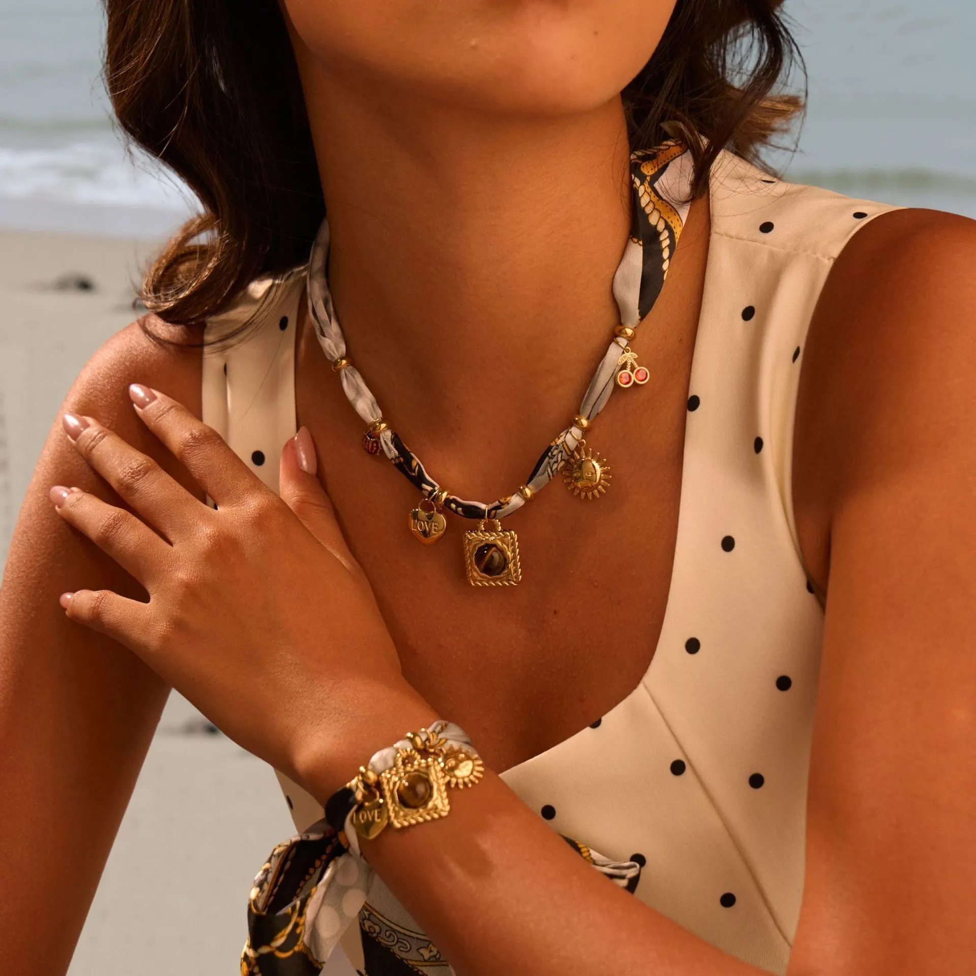Gold tone 18K electroplated stainless steel necklace with regular chain on white background