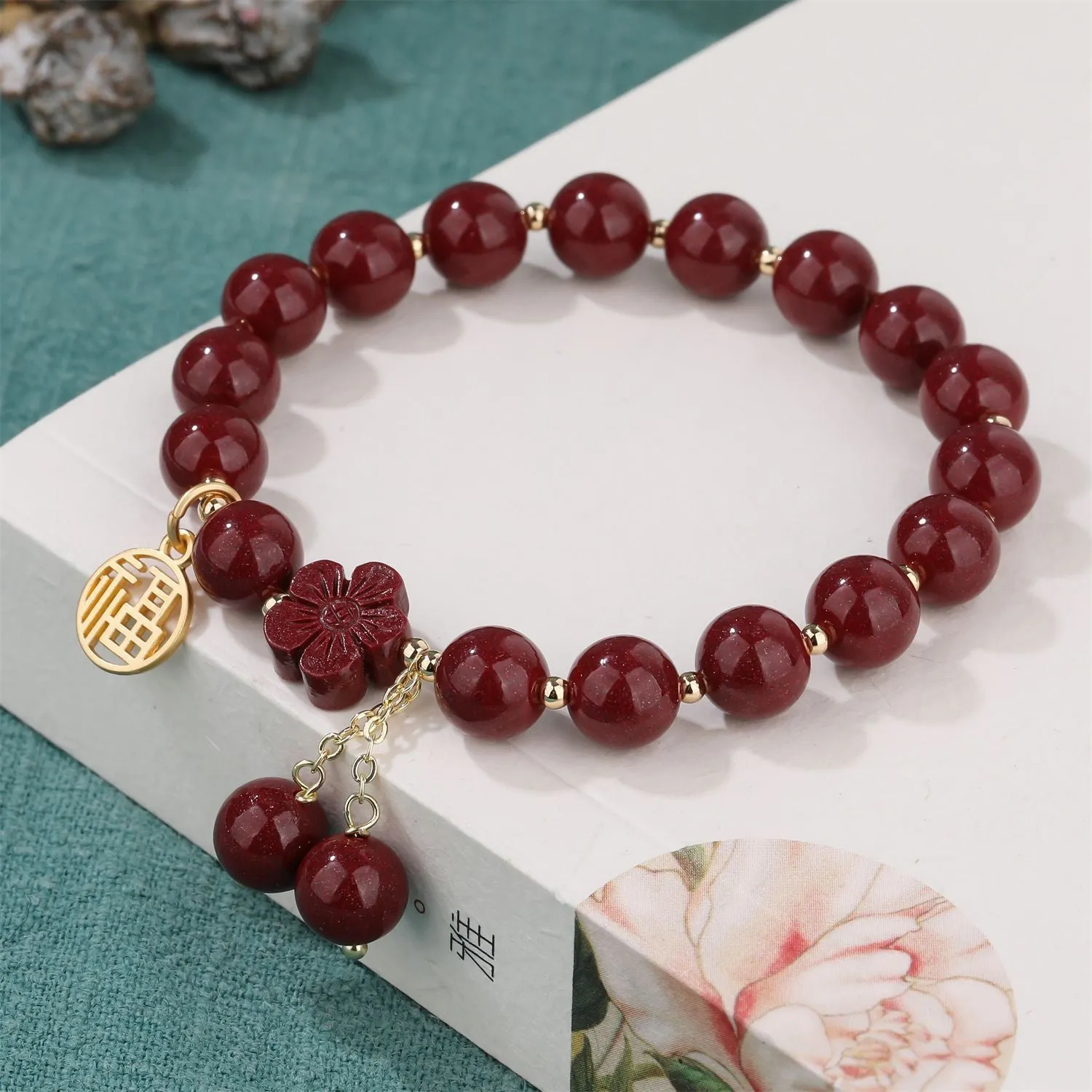 Women's cinnabar bracelet with Fu character charm and peach blossom tassels in purple gold sand colour