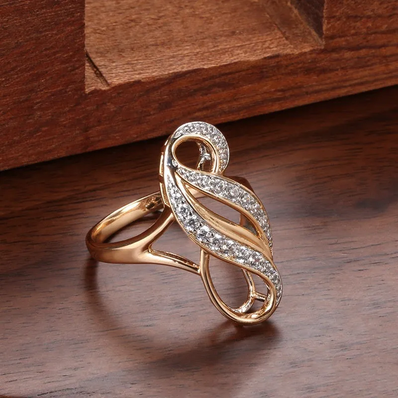 Rose gold irregular geometric drop shape ring with gold-plated inlay and artificial gemstone on copper base.