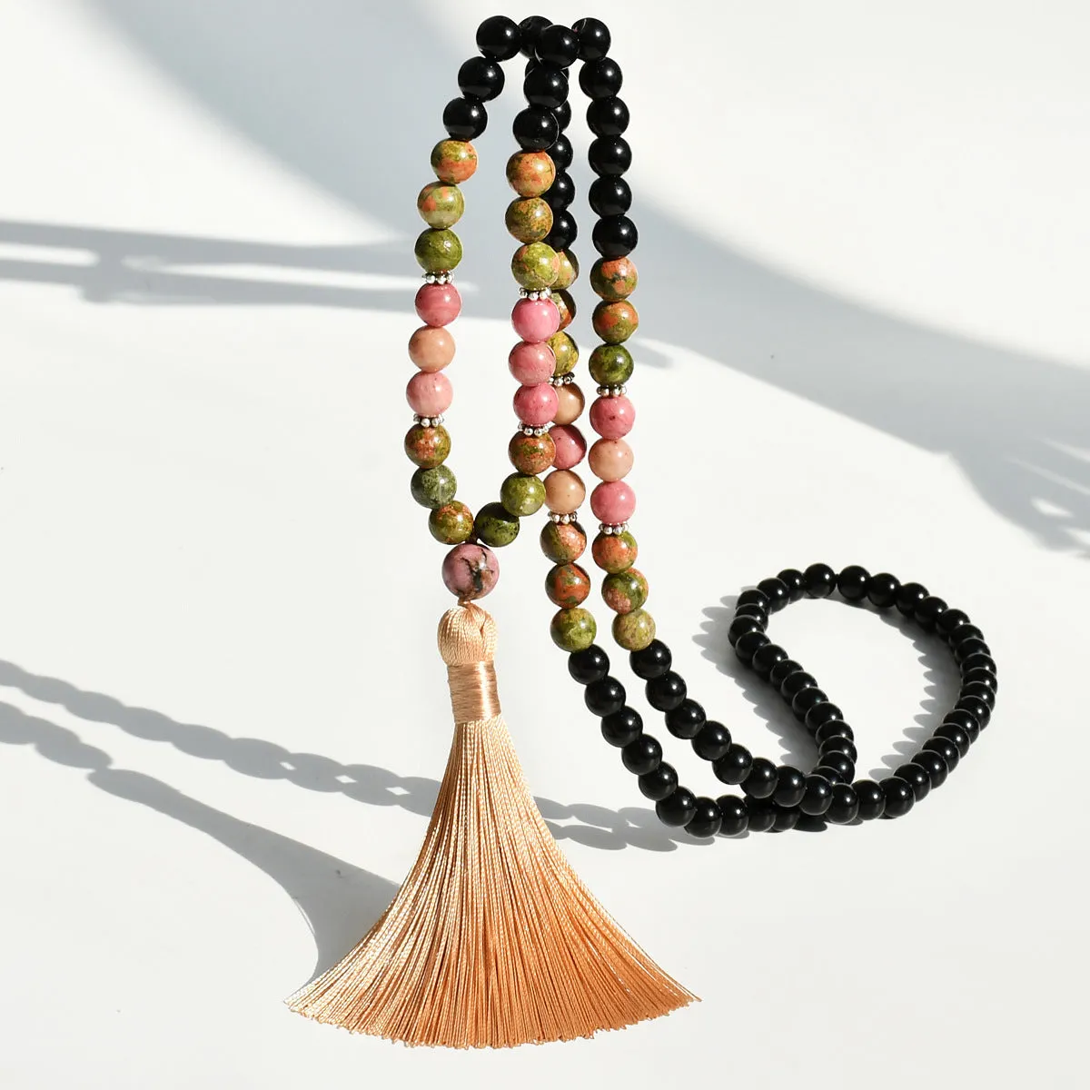 Long beaded bohemian necklace with 108 gemstone tassel pendants on a ball chain.