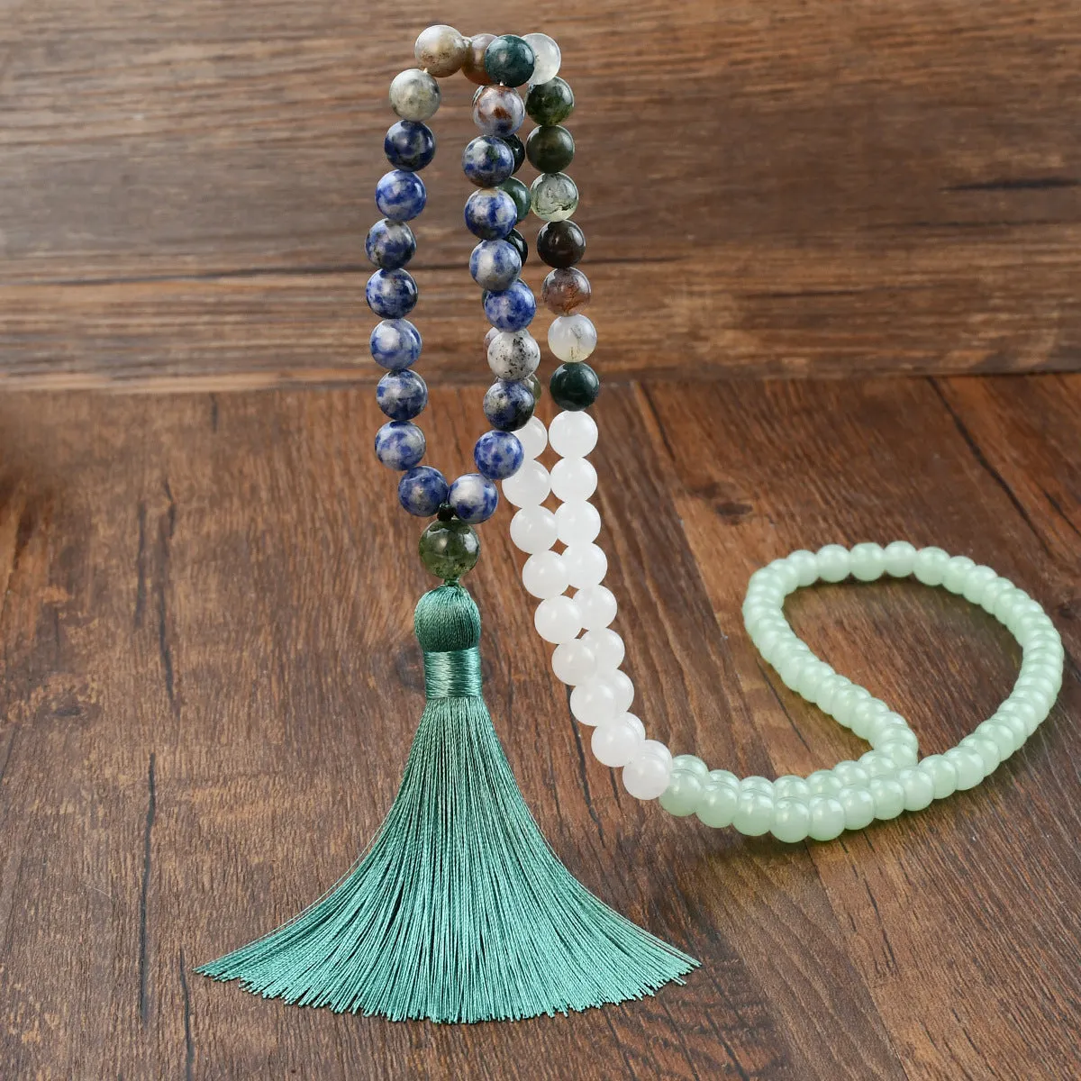 Long beaded bohemian necklace with 108 gemstone tassel pendants on a ball chain.