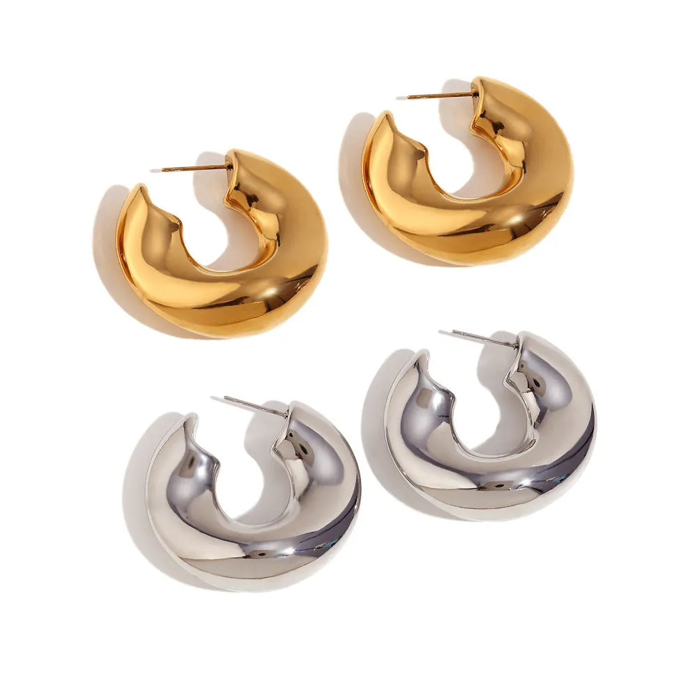 Gold and silver hollow irregular stainless steel earrings with geometric line design on white background