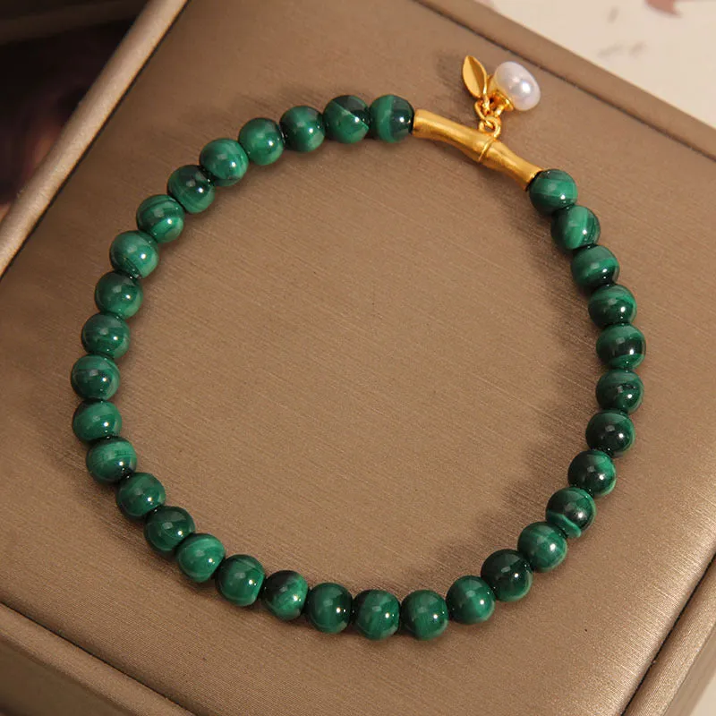Women's white crystal lucky bamboo bracelet with adjustable clasp on a wrist.
