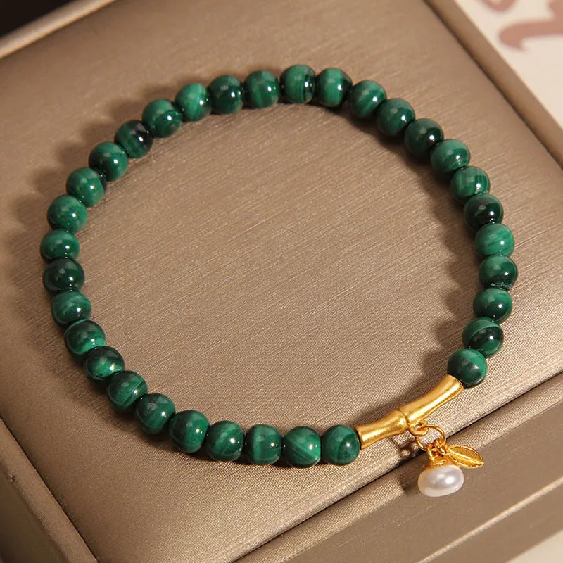 Women's white crystal lucky bamboo bracelet with adjustable clasp on a wrist.