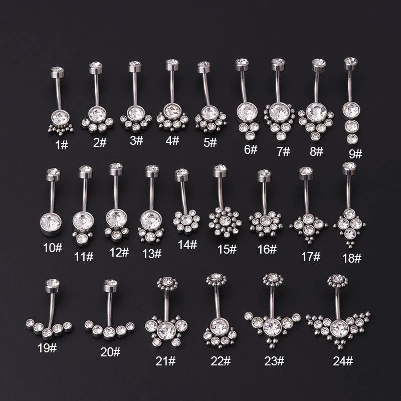 Gold stainless steel belly button ring with clear artificial gemstone inlay on white background