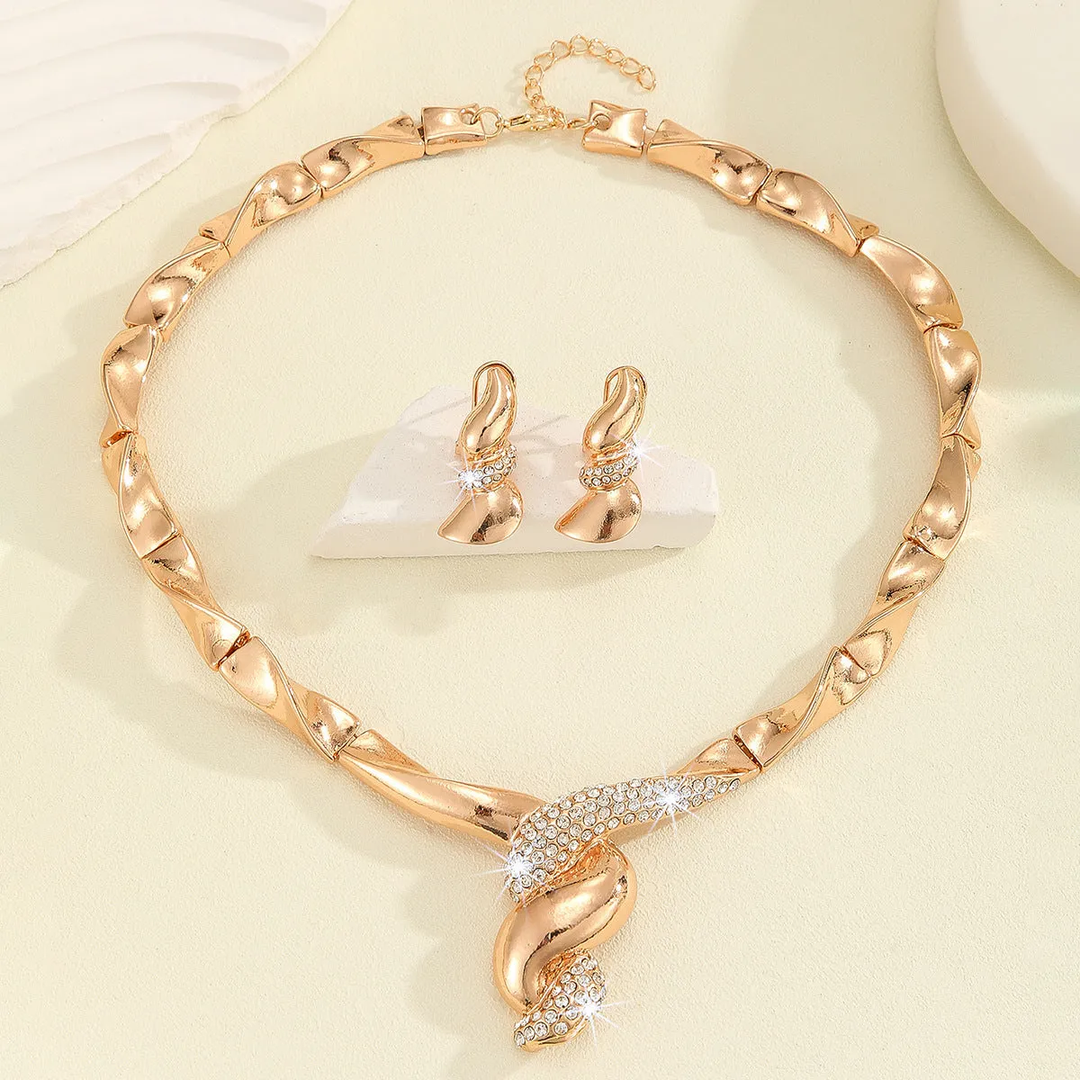 Gold alloy thread necklace and earrings suite with love heart pattern on a white background