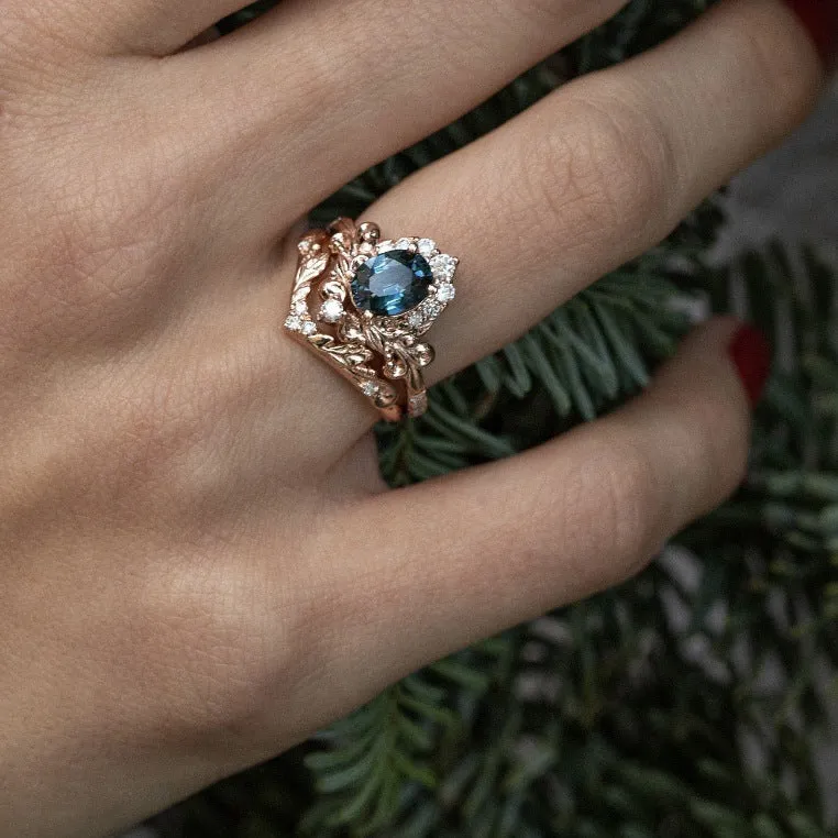 Women's rose gold branch flower ring with inlaid blue crystal, alloy construction, side view on finger