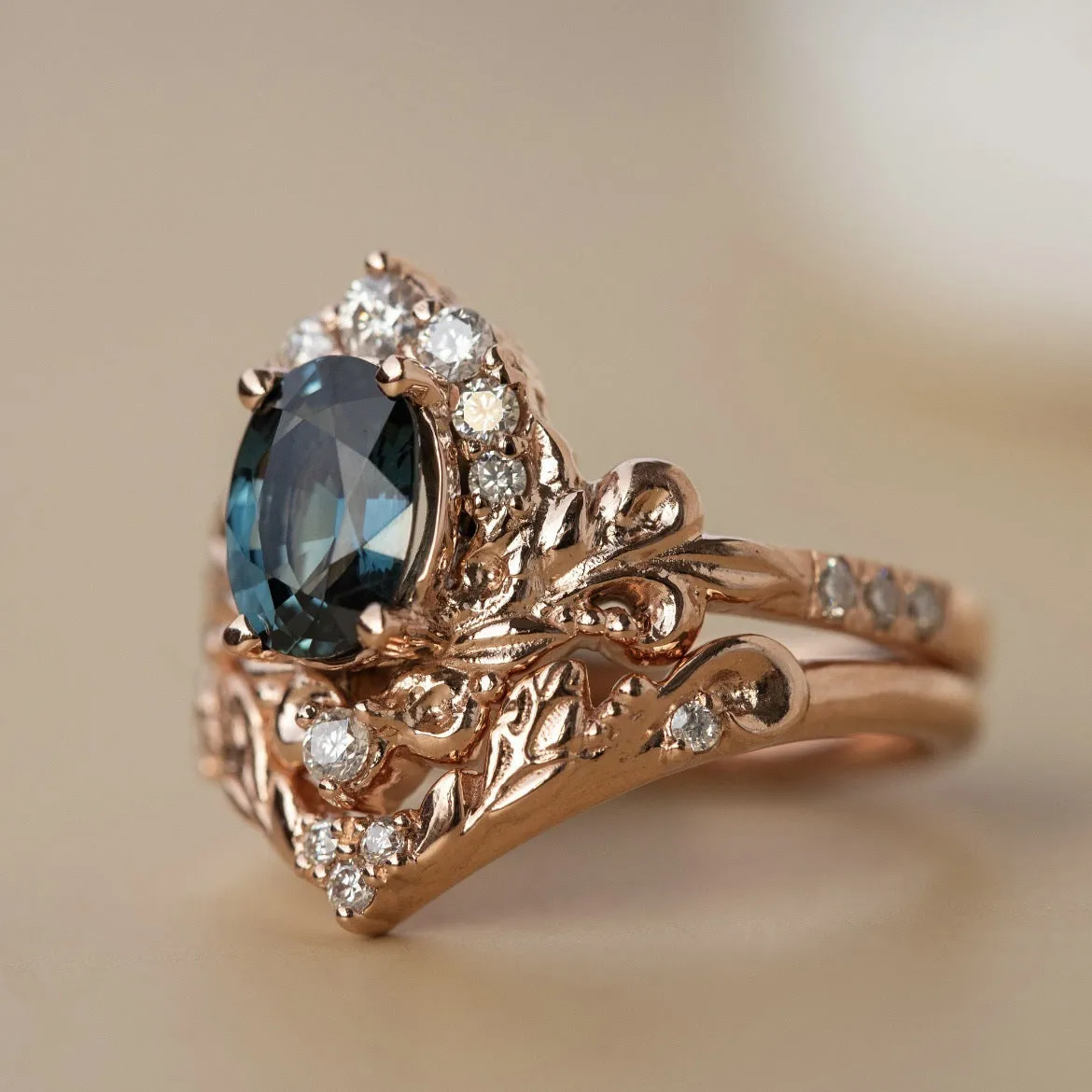 Women's rose gold branch flower ring with inlaid blue crystal, alloy construction, side view on finger