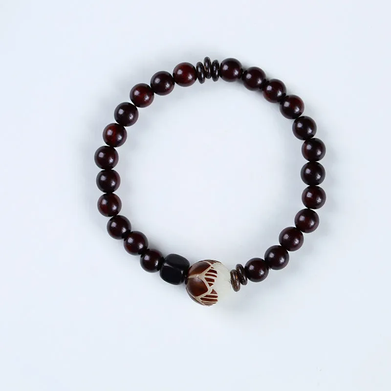 Rosewood bracelet with knitted construction showing floral carving details and 10mm diameter