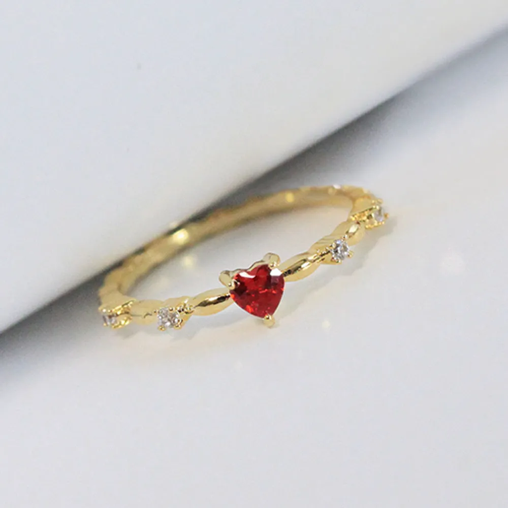 Gold and silver electroplated peach heart ring with zircon stones on a copper base.