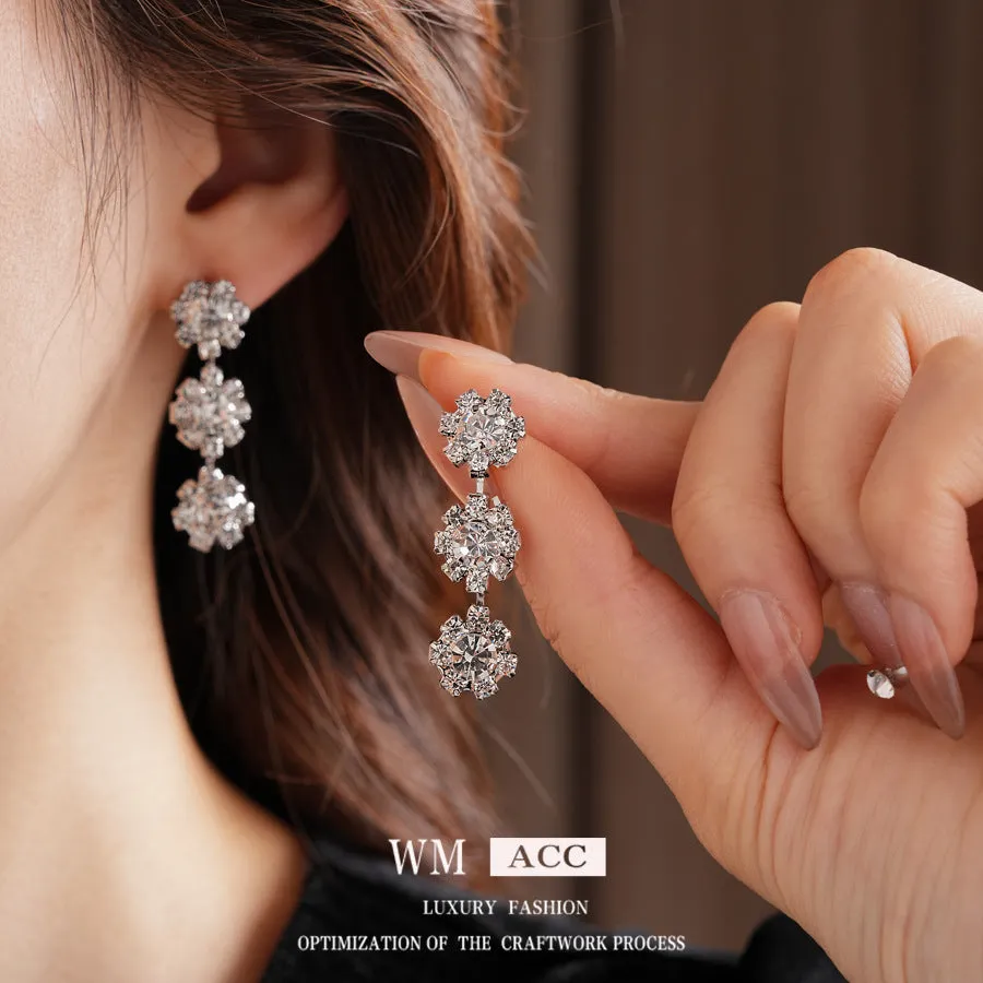 Diamond sunflower earrings and necklace set in silver finish on display
