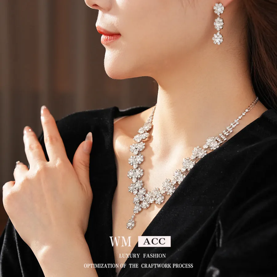 Diamond sunflower earrings and necklace set in silver finish on display