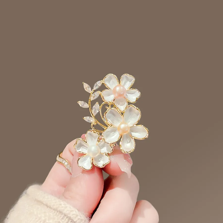 Alloy brooch in natural flower shape with electroplated finish, featuring adjustable and anti-exposure pin closure for women's coats and suits.
