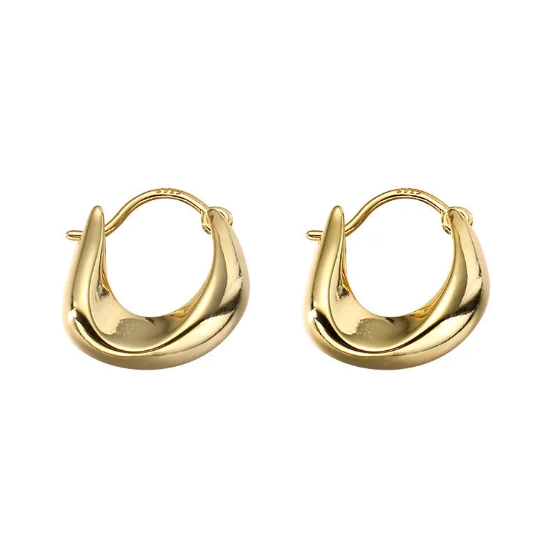 Gold pair of irregular geometric earrings with 925 silver needle posts on white background
