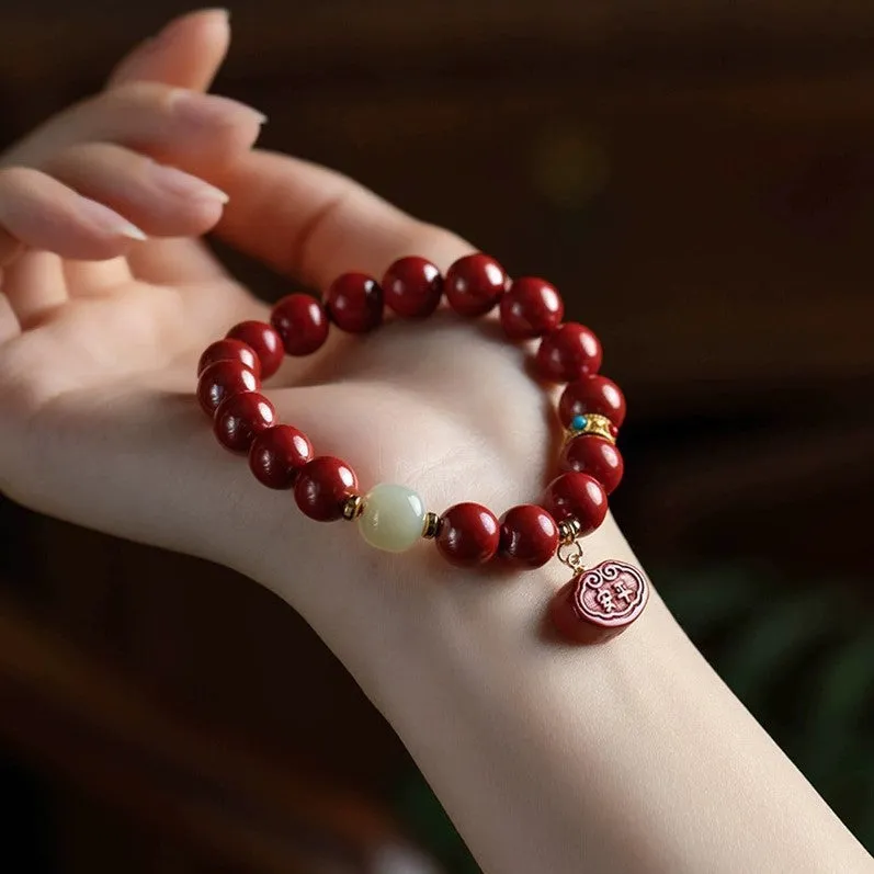 Red cinnabar Emperor Sandstone Ping An Fu Lu adjustable bracelet on wrist.