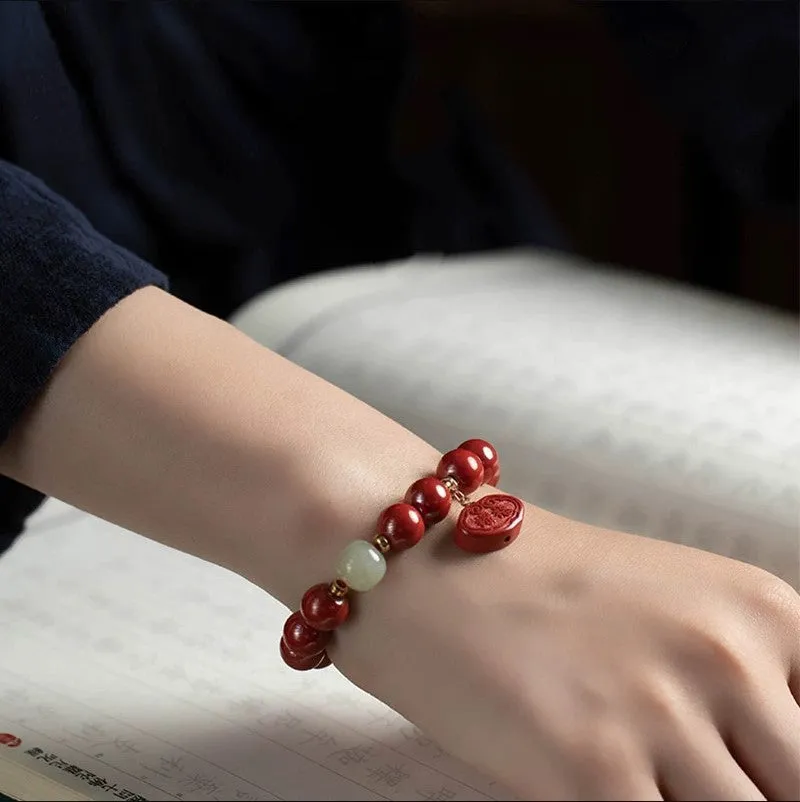 Red cinnabar Emperor Sandstone Ping An Fu Lu adjustable bracelet on wrist.