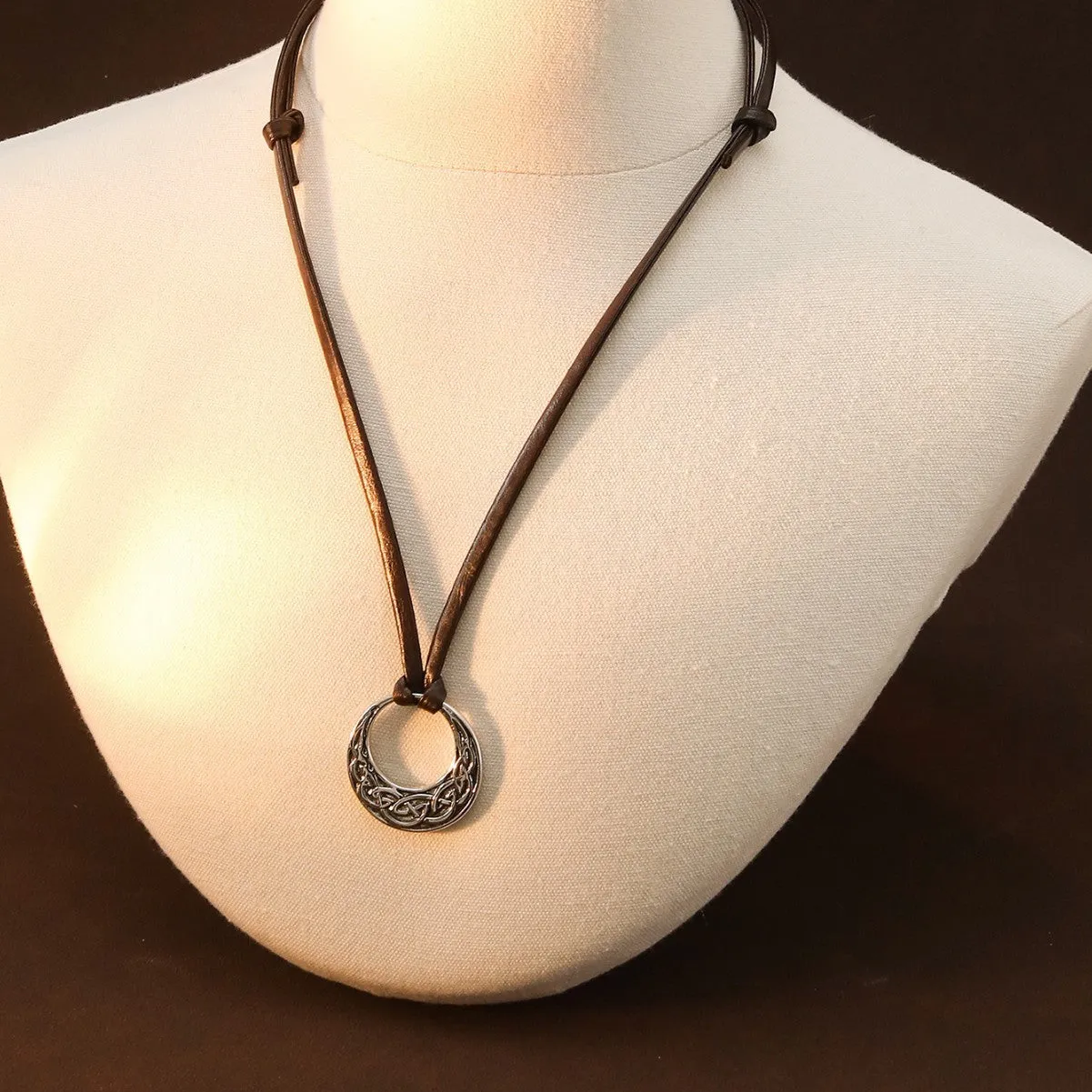 Alloy skull pendant necklace with adjustable knot chain in antique silver on a neutral background