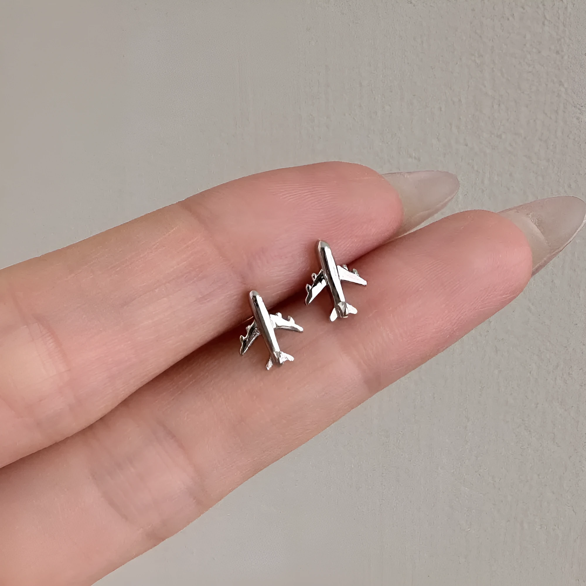 Pair of S925 sterling silver stud earrings with aircraft motif, platinum electroplated finish