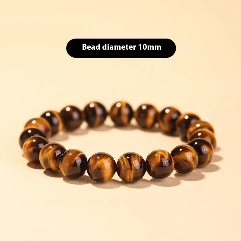 Tigereye Dzi bead single circle Buddha rosary bracelet on a wrist.