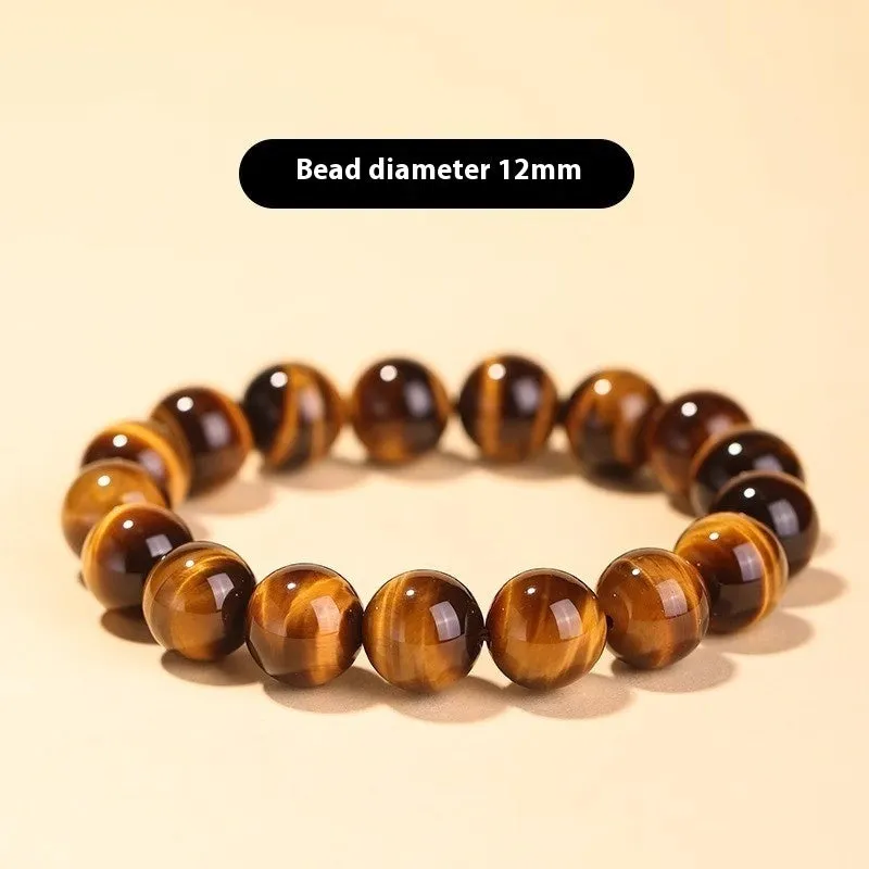 Tigereye Dzi bead single circle Buddha rosary bracelet on a wrist.