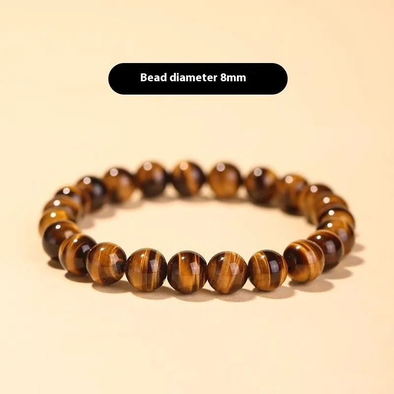 Tigereye Dzi bead single circle Buddha rosary bracelet on a wrist.