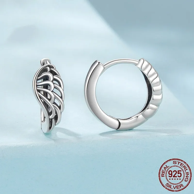 Pair of vintage S925 sterling silver wings ear clip earrings in silver colour on white background