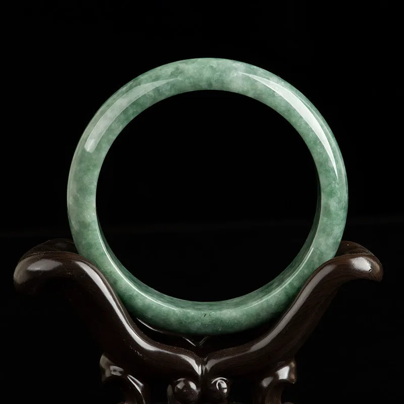 Natural deep pea green jade bangle bracelet for women on a gift box.