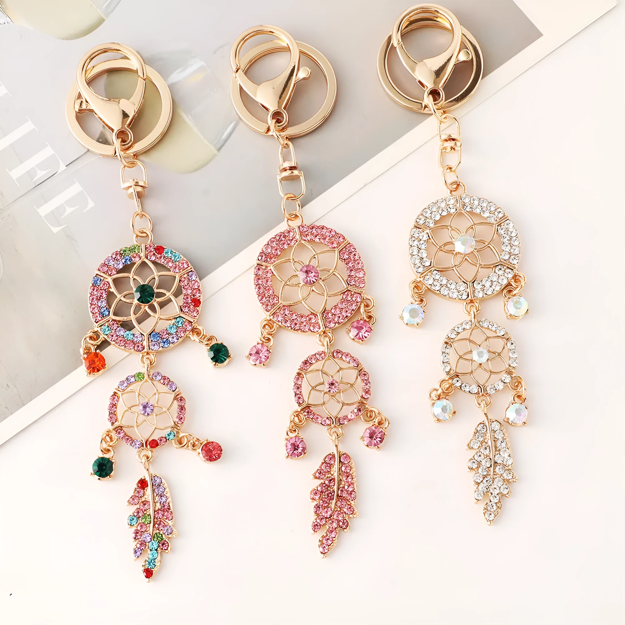 Creative diamond studded flower shaped car keychain dream catcher in pink alloy light luxury style on white background