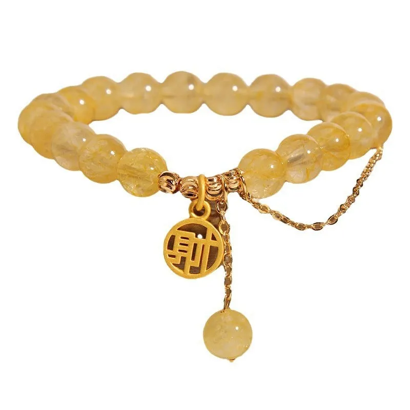 Natural citrine stone bracelet with Chinese character charm and dangling tassel.