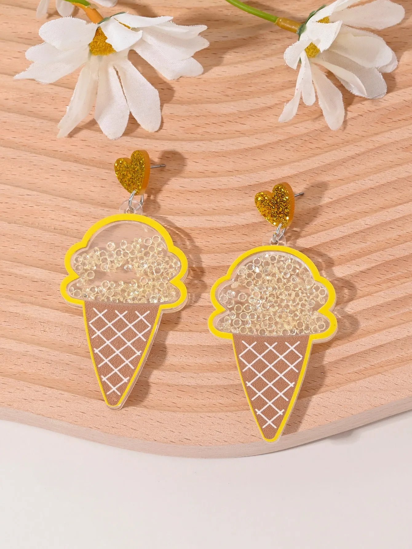 Colourful acrylic earrings with realistic fruit and dessert charms including cherry, strawberry, and ice cream.