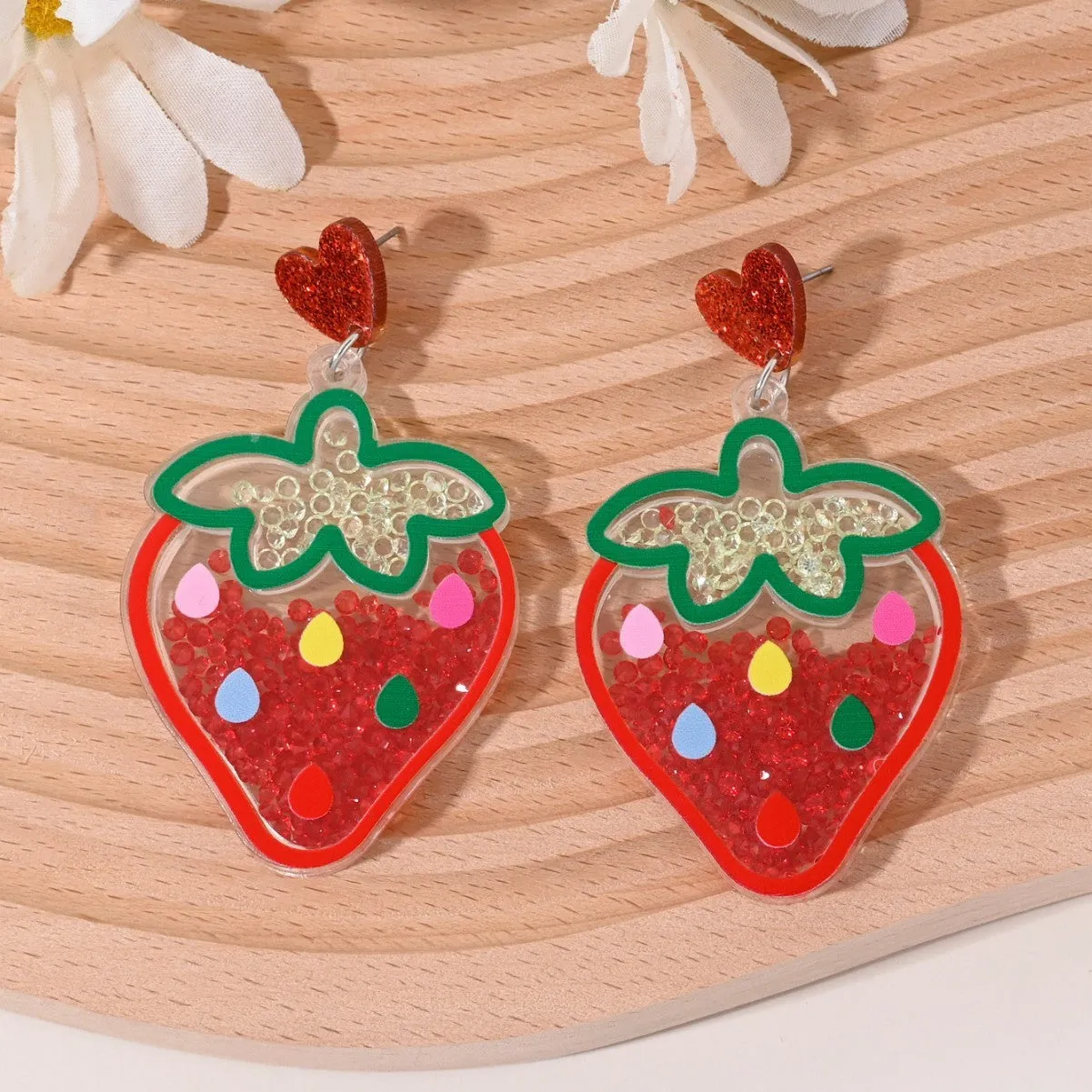 Colourful acrylic earrings with realistic fruit and dessert charms including cherry, strawberry, and ice cream.