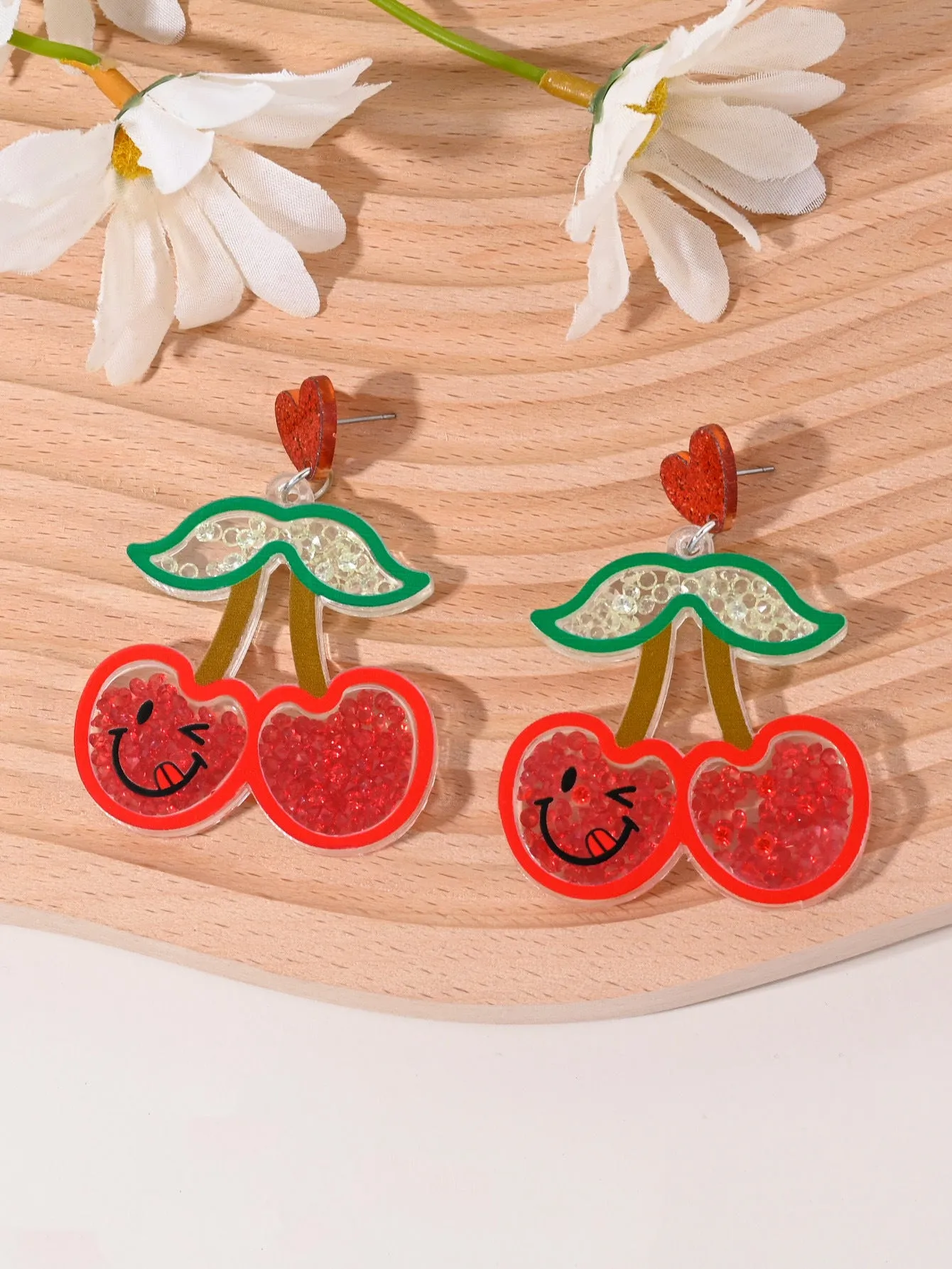 Colourful acrylic earrings with realistic fruit and dessert charms including cherry, strawberry, and ice cream.