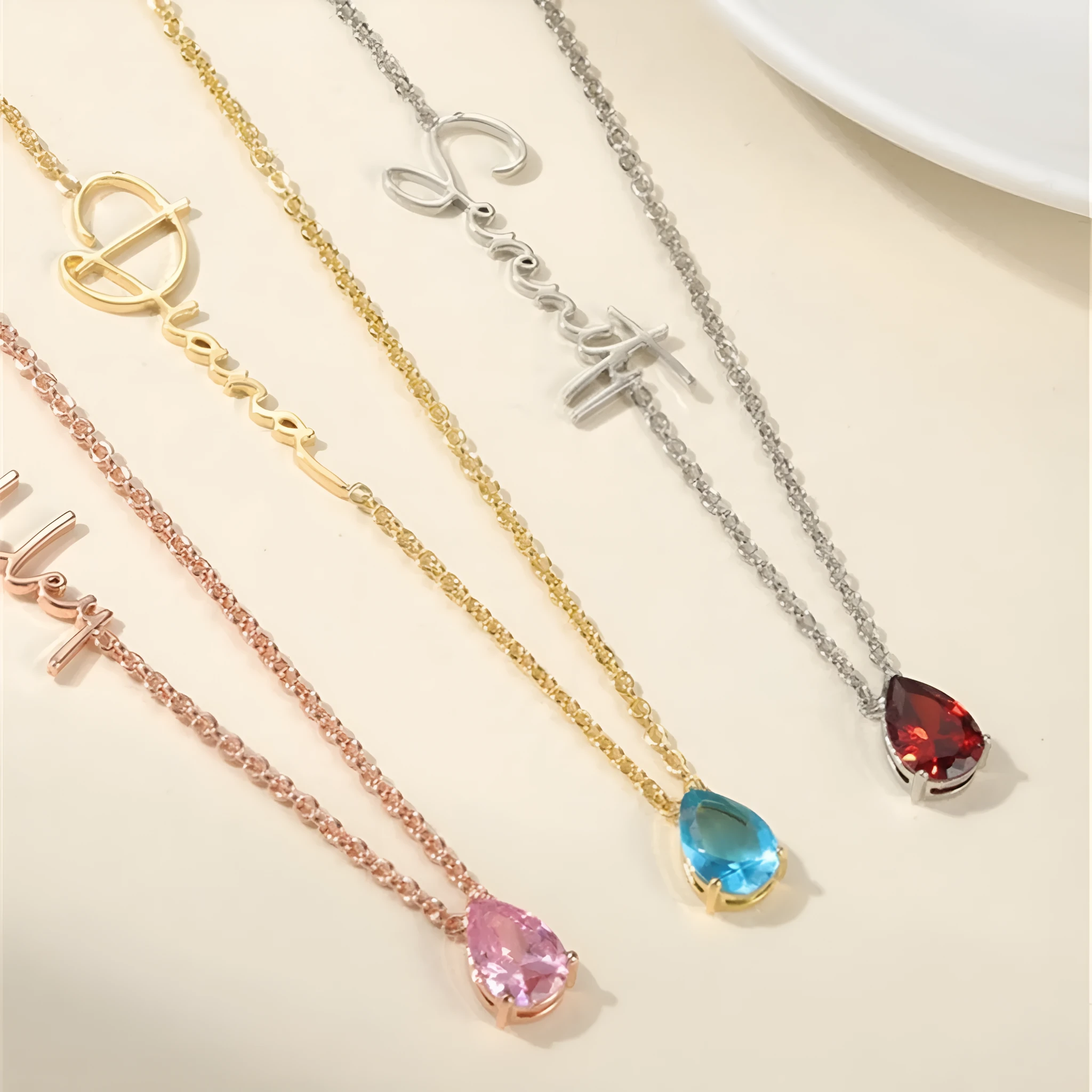 Stainless steel custom name necklace with DIY personalised pendant in silver finish on a plain background