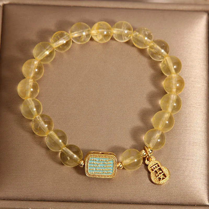Yellow citrine crystal women's bracelet with rhinestone detailing on wrist