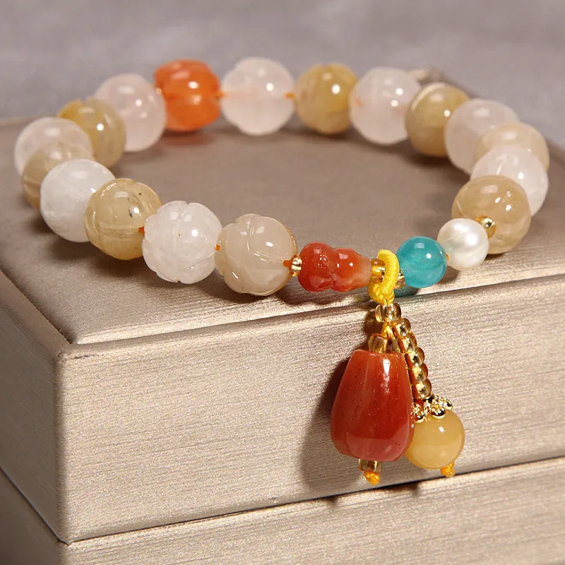 Women's multi-layer crystal bracelet with natural garnet, strawberry quartz pendants, and jinsi jade beads in assorted colours.