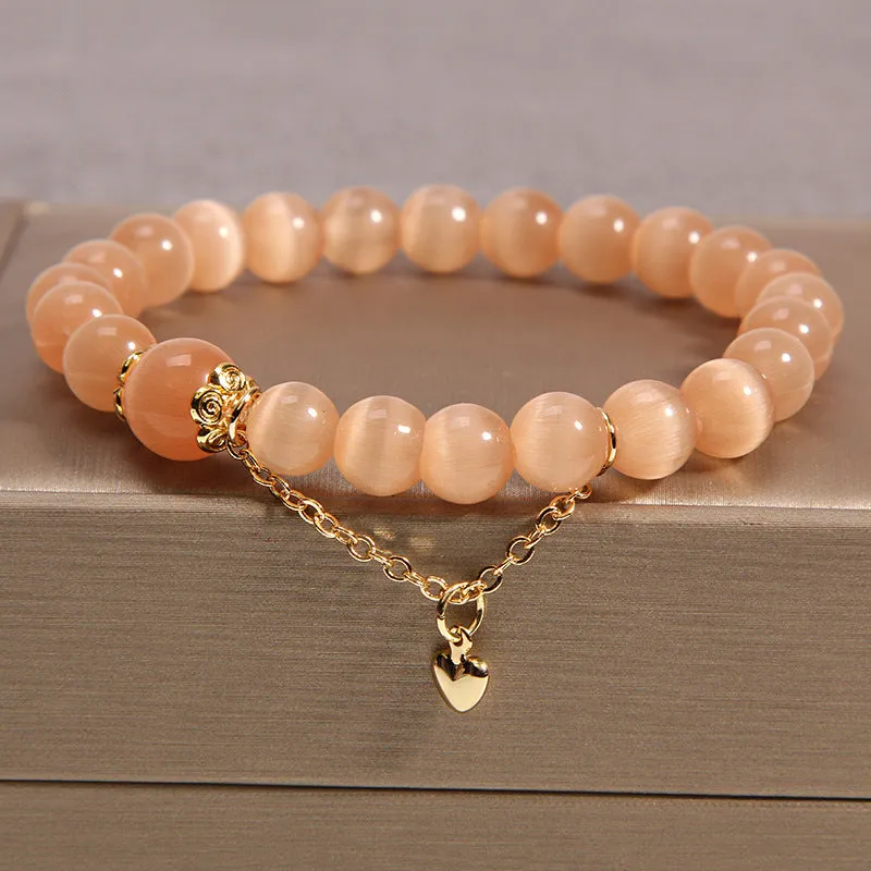 Women's multi-layer crystal bracelet with natural garnet, strawberry quartz pendants, and jinsi jade beads in assorted colours.