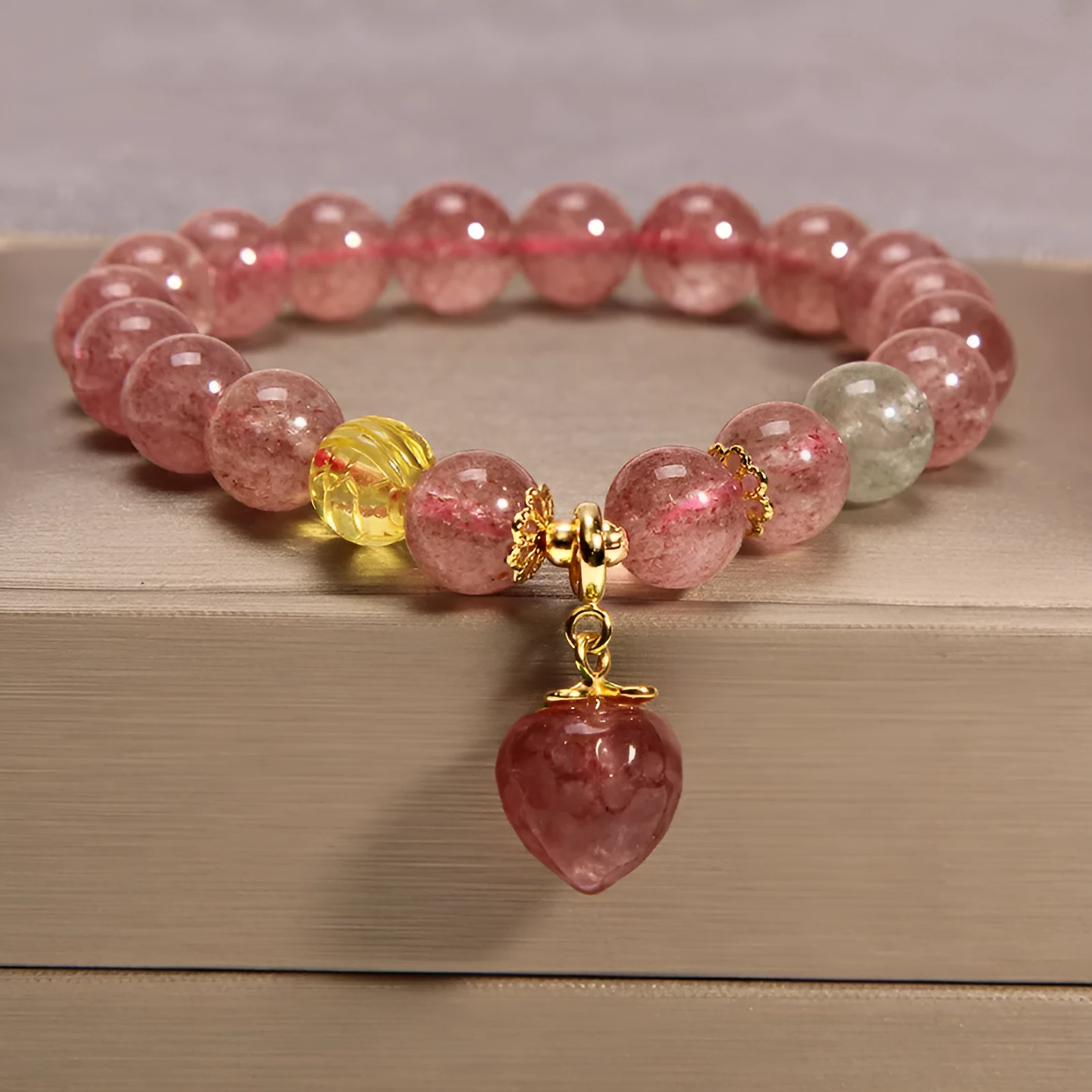 Women's multi-layer crystal bracelet with natural garnet, strawberry quartz pendants, and jinsi jade beads in assorted colours.