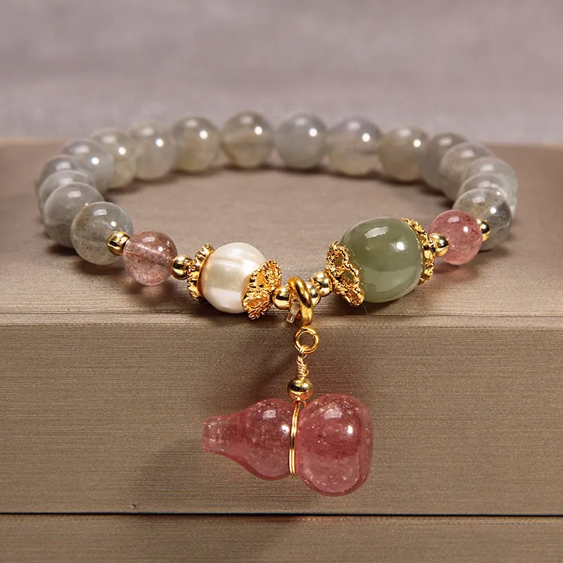 Women's multi-layer crystal bracelet with natural garnet, strawberry quartz pendants, and jinsi jade beads in assorted colours.