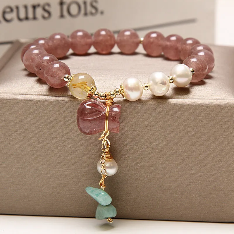 Women's multi-layer crystal bracelet with natural garnet, strawberry quartz pendants, and jinsi jade beads in assorted colours.
