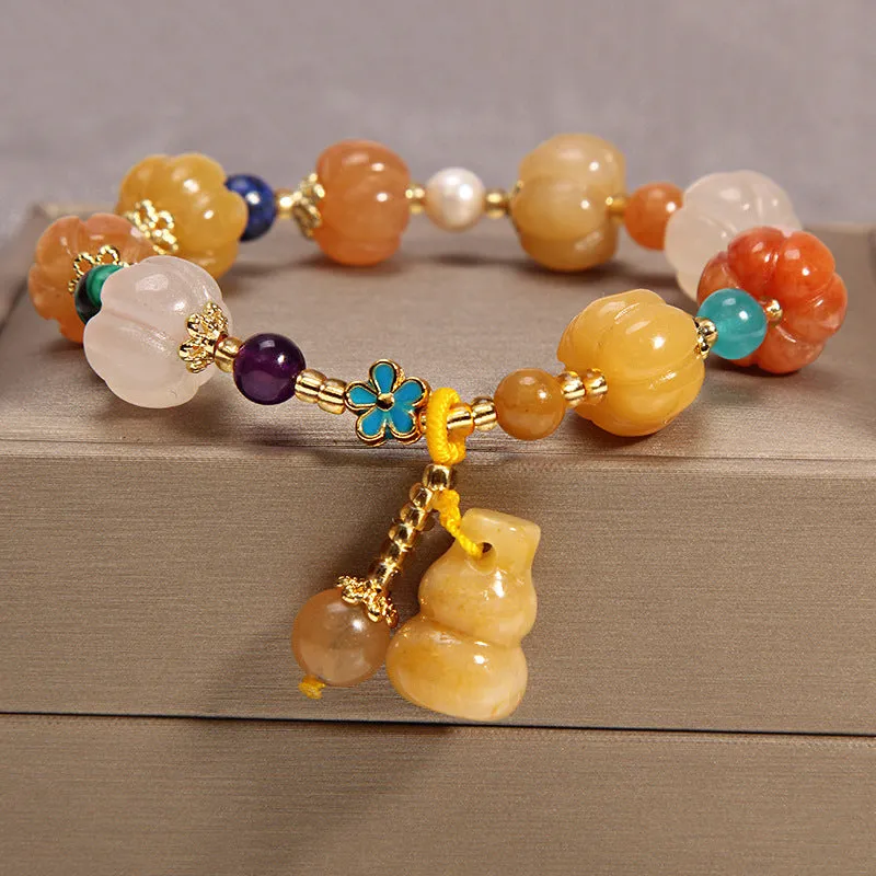 Women's multi-layer crystal bracelet with natural garnet, strawberry quartz pendants, and jinsi jade beads in assorted colours.