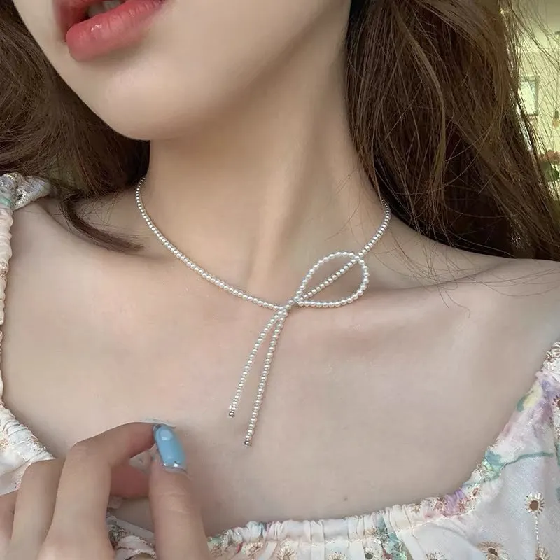 Unisex magnetic sweater necklace with mother pearl shellfish pendant and organic glass setting on electroplated chain, available in multiple colours