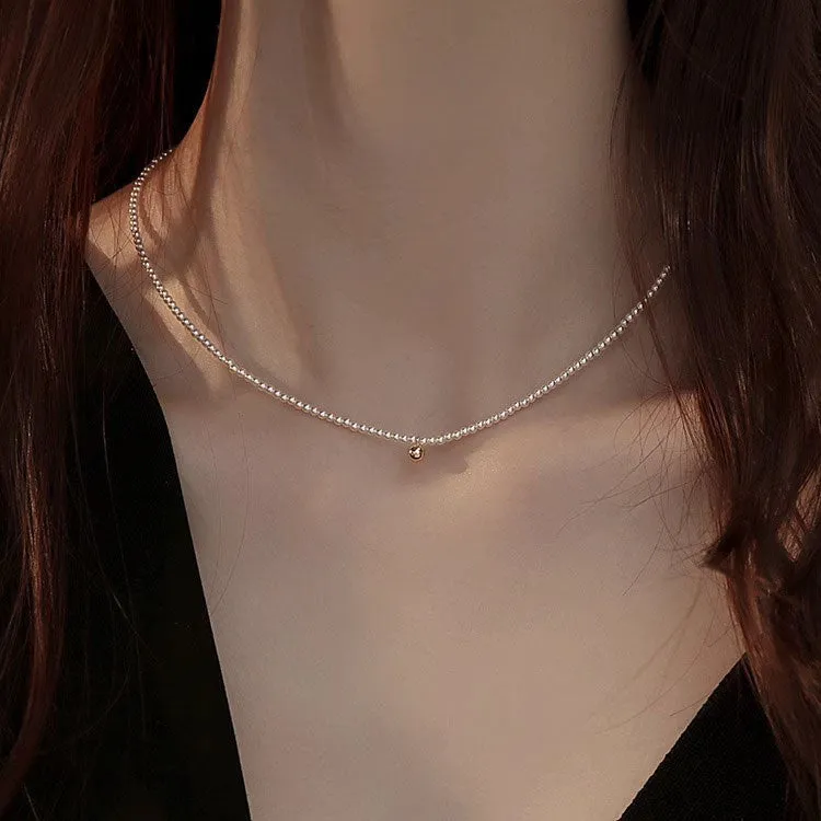 Unisex magnetic sweater necklace with mother pearl shellfish pendant and organic glass setting on electroplated chain, available in multiple colours