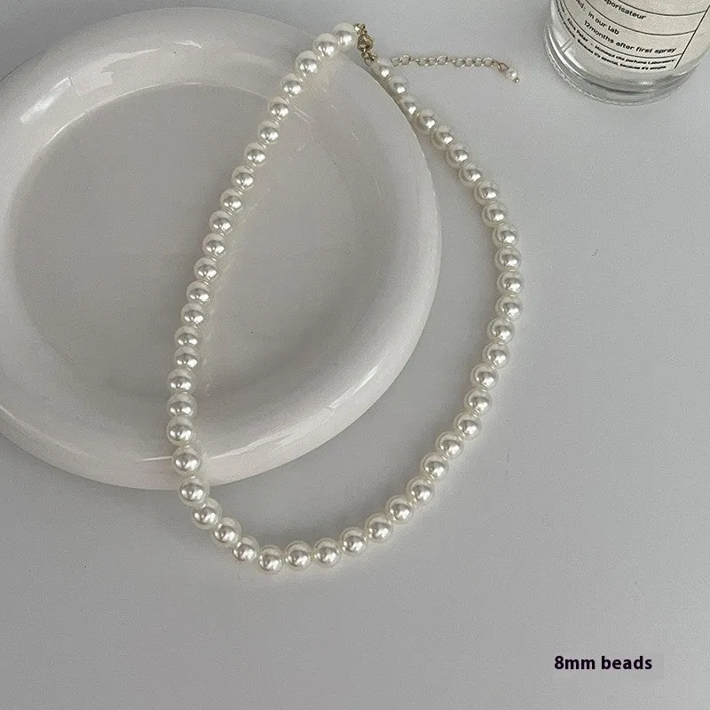Unisex magnetic sweater necklace with mother pearl shellfish pendant and organic glass setting on electroplated chain, available in multiple colours
