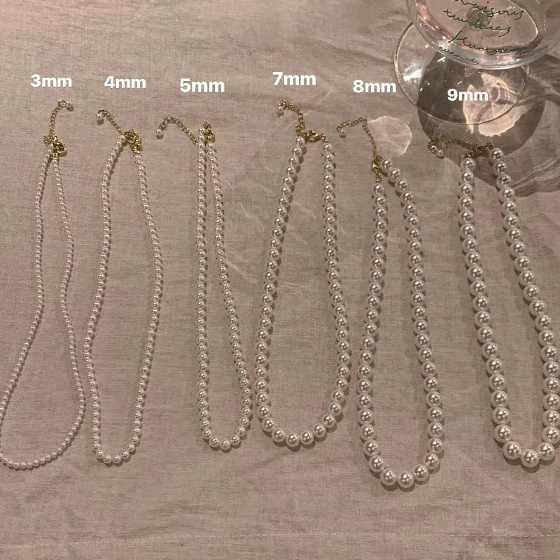 Unisex magnetic sweater necklace with mother pearl shellfish pendant and organic glass setting on electroplated chain, available in multiple colours