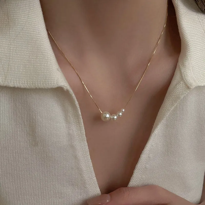 Unisex magnetic sweater necklace with mother pearl shellfish pendant and organic glass setting on electroplated chain, available in multiple colours