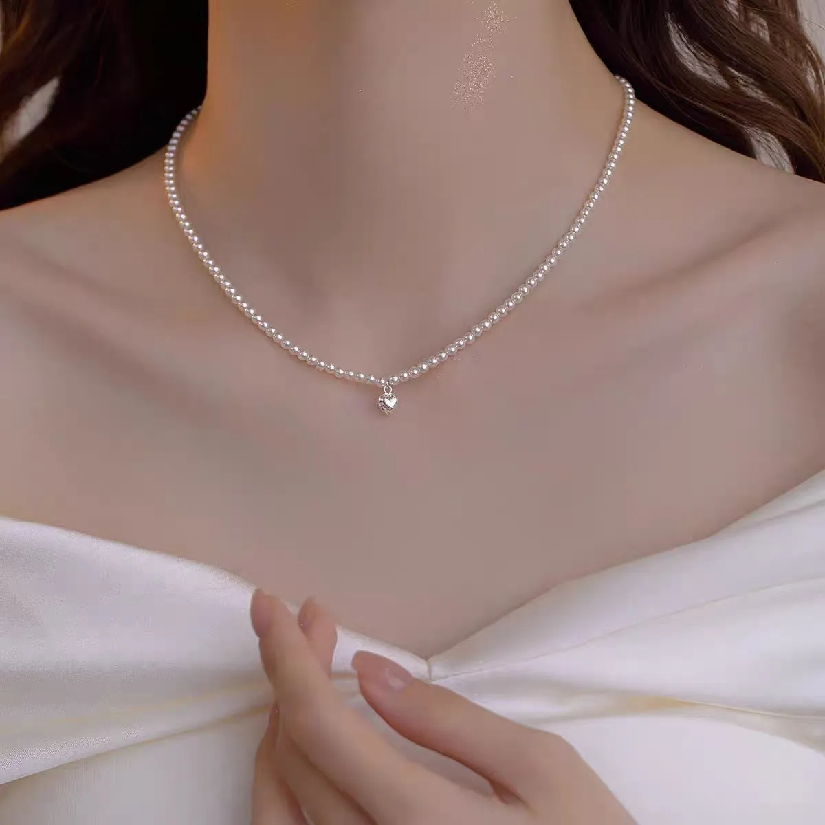 Unisex magnetic sweater necklace with mother pearl shellfish pendant and organic glass setting on electroplated chain, available in multiple colours