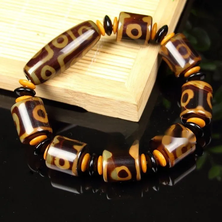 Distressed agate Tibet beads bracelet with three eye dzi design and polished stone beads
