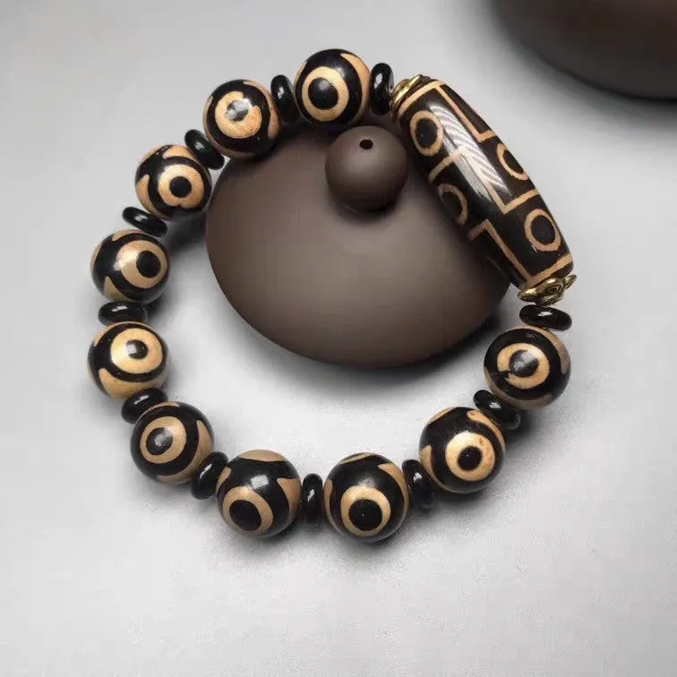 Distressed agate Tibet beads bracelet with three eye dzi design and polished stone beads